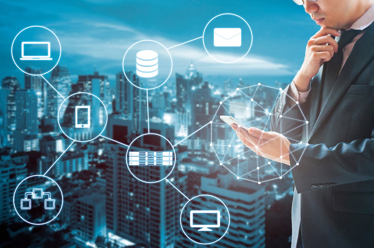 Double exposure of businessman connected internet and wireless network with his smart phone and city