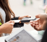 Credit card being passed on a POS at a retail store