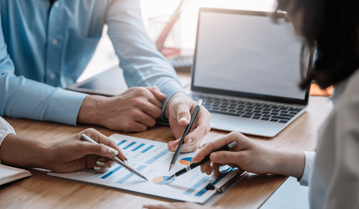 Business people meeting explaining the financial graph data and marketing plan.