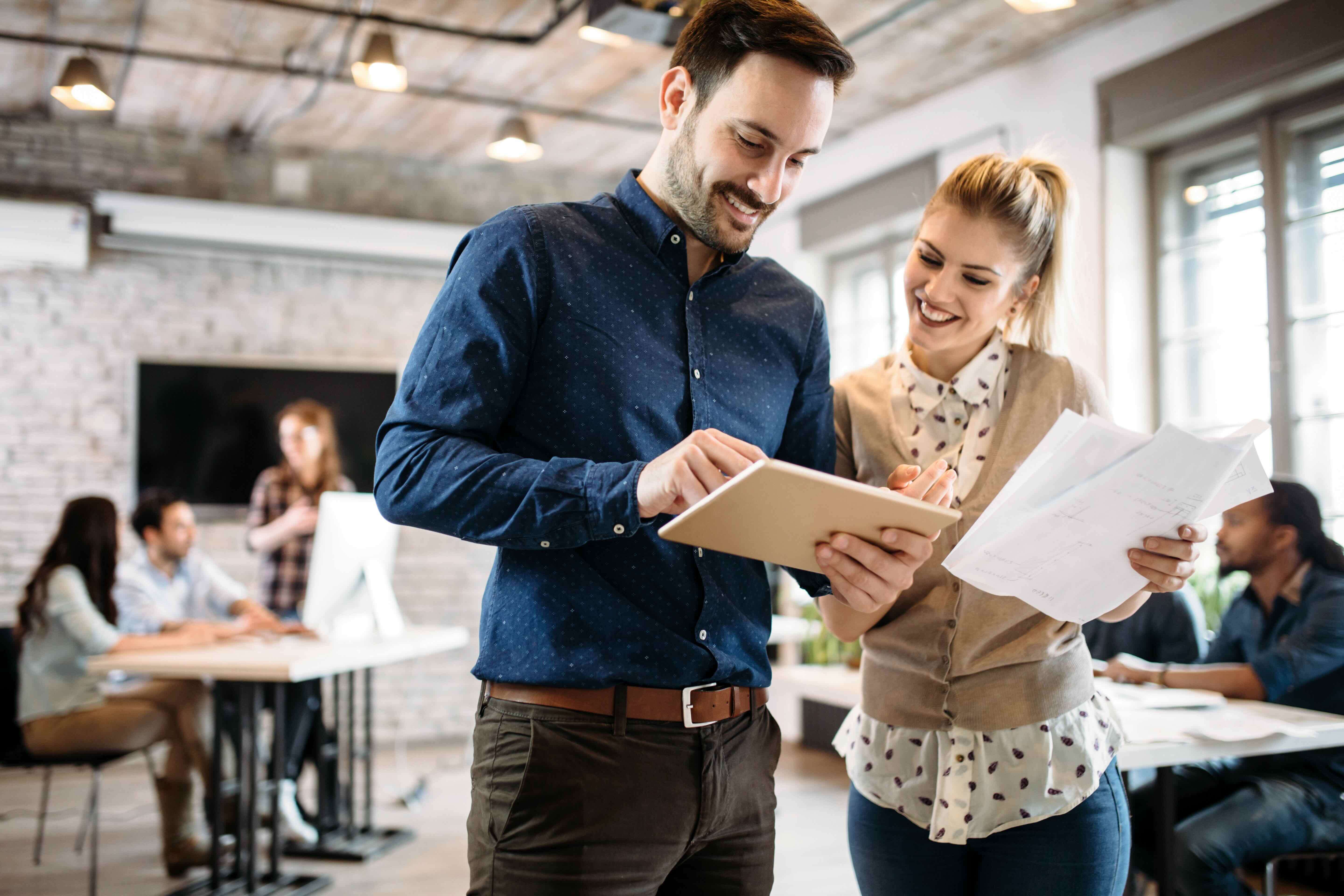 Man and woman looking at tablet screen in office