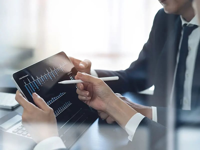 A businessman is in a discussion with a colleague in the office.