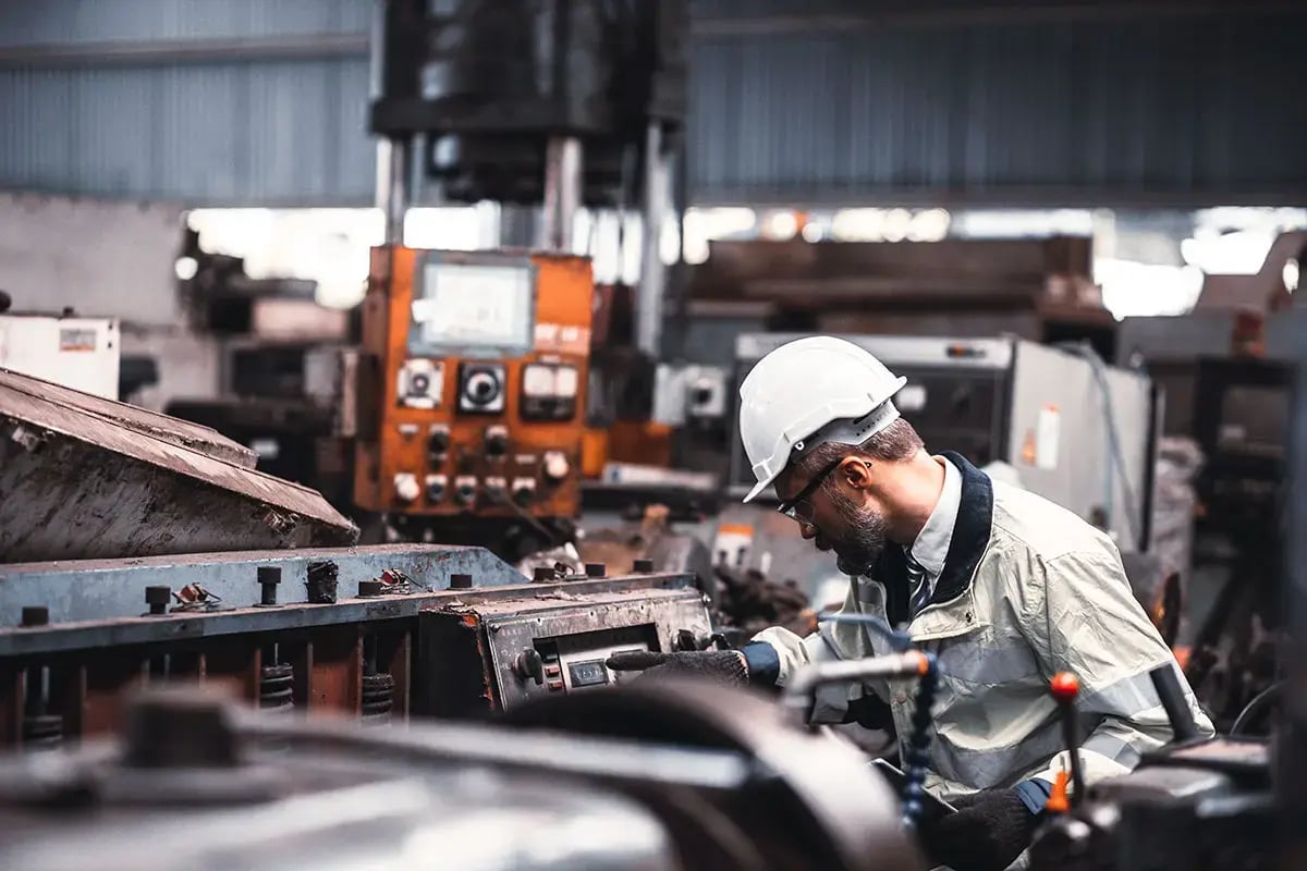 An industrial engineer is inspecting machinery.