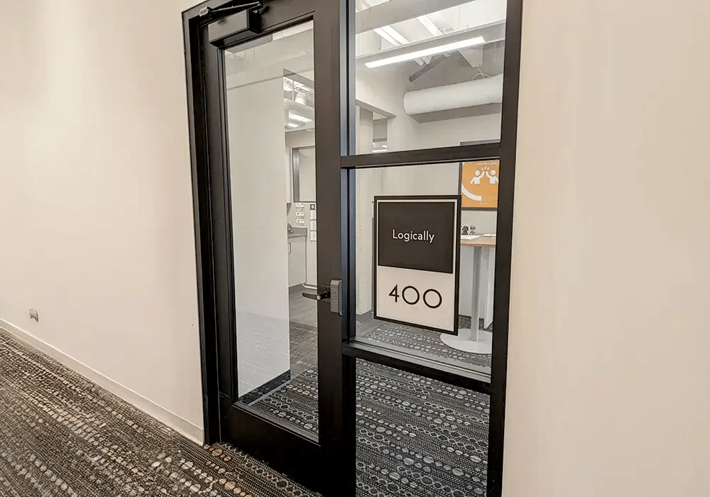 Glass office door with a black frame showing room number 400 and the name 