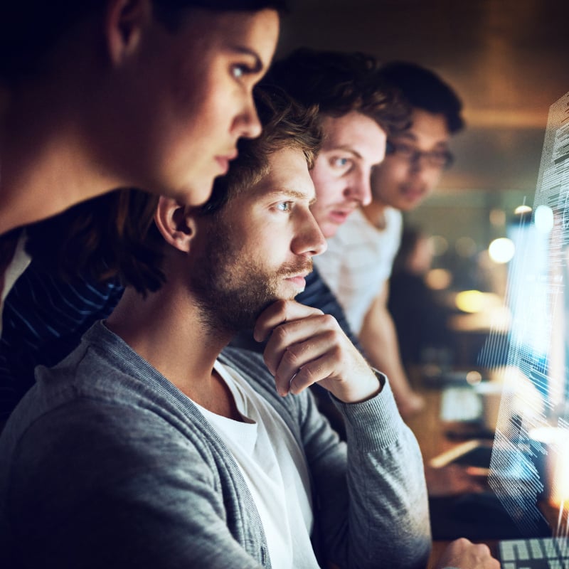 team-looking-at-digital-screen