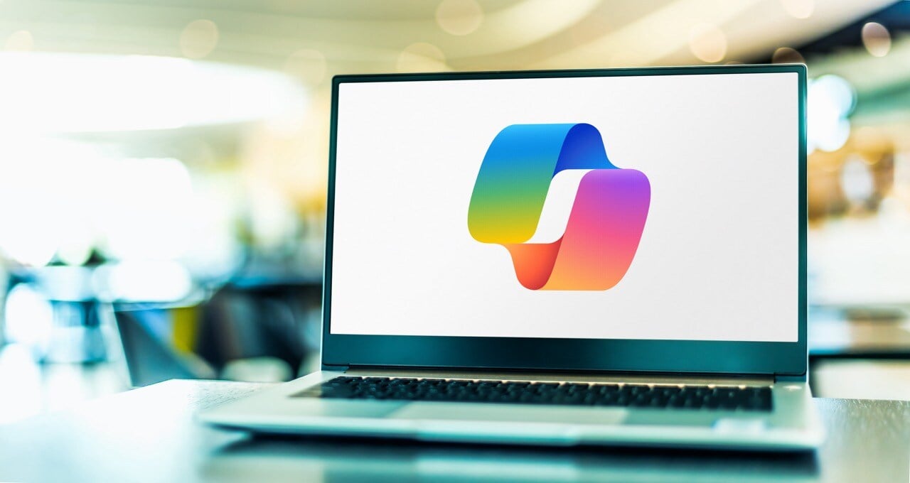 Laptop screen displaying a colorful, abstract logo on a white background.