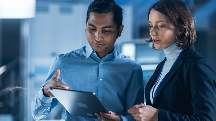 Man and woman looking at tablet screen